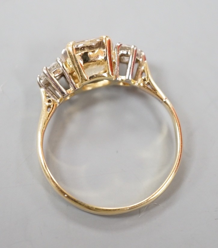 A yellow metal, singe stone oval cut yellow sapphire and two stone round cut diamond set ring, size N/O, gross weight 2.9 grams.